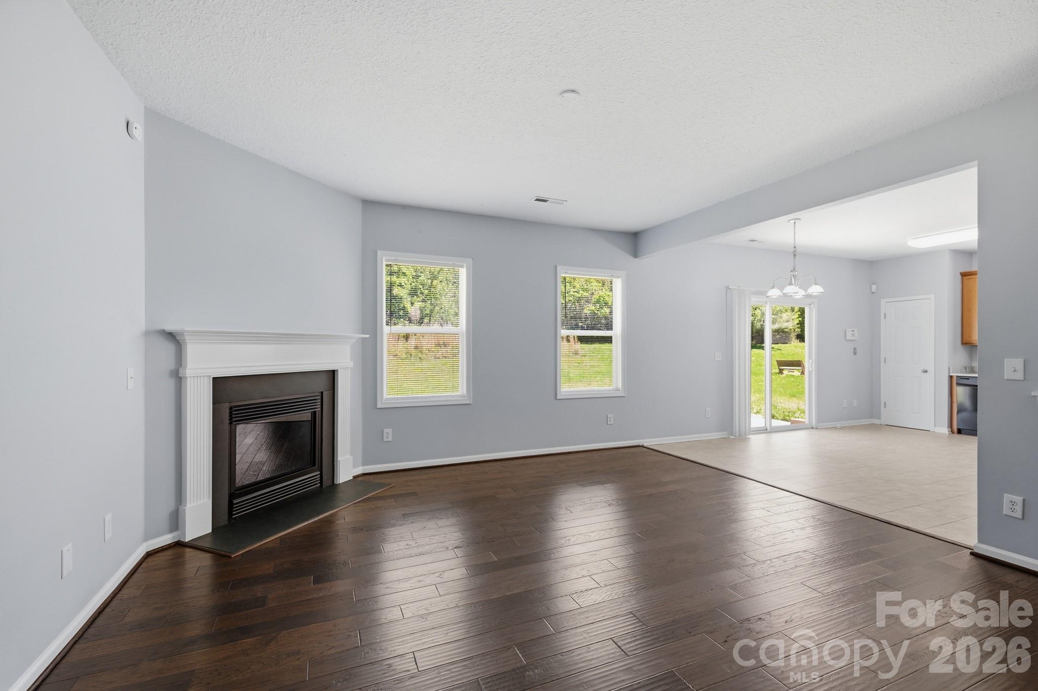6404 Trotters Ridge Road Charlotte, NC 28227 - Photo 10 of 29 a view of an empty room with window and wooden floor