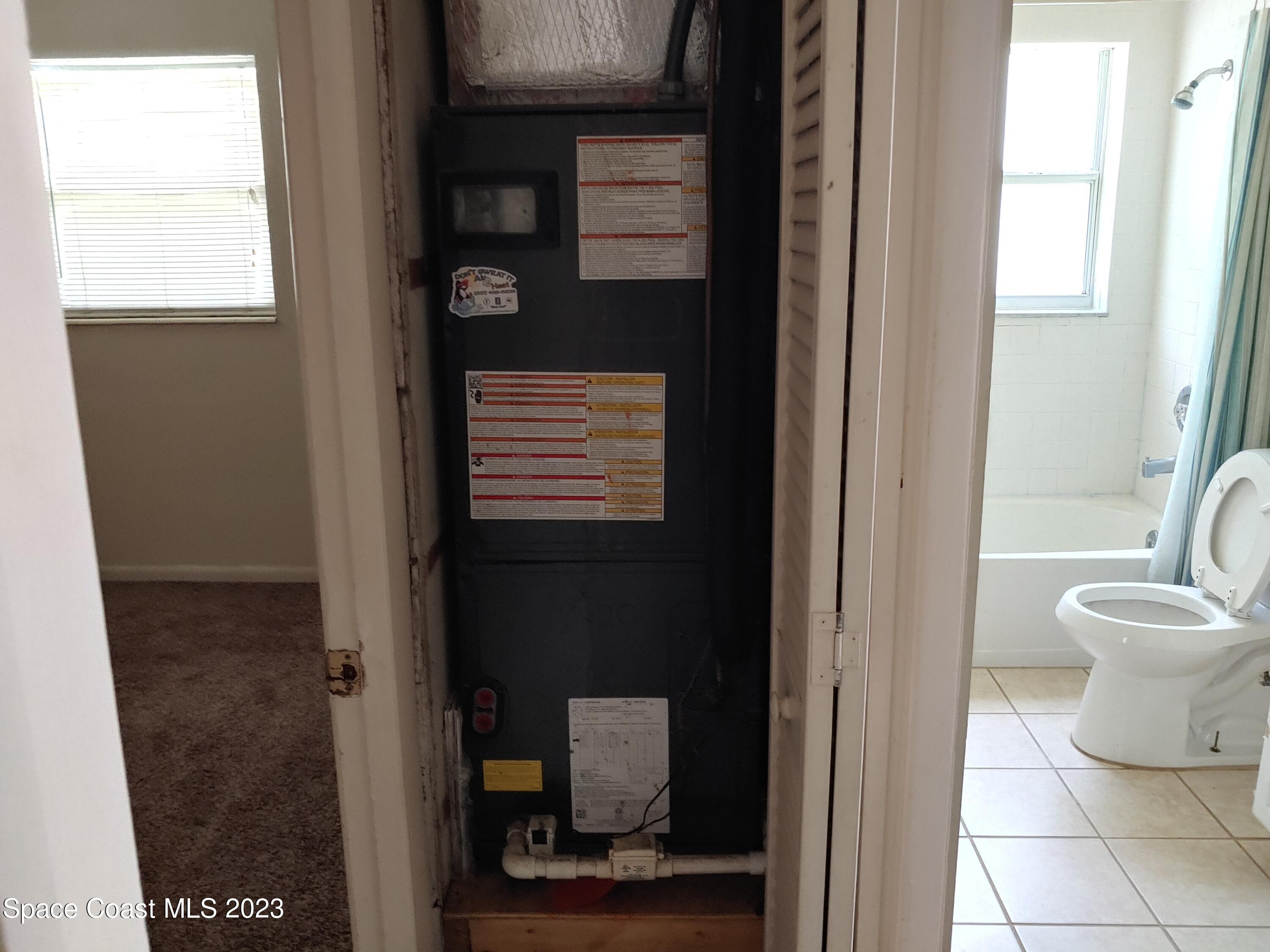 2579 Pepper Avenue Melbourne, FL 32935 - Photo 4 of 5 a bathroom with a toilet and a sink