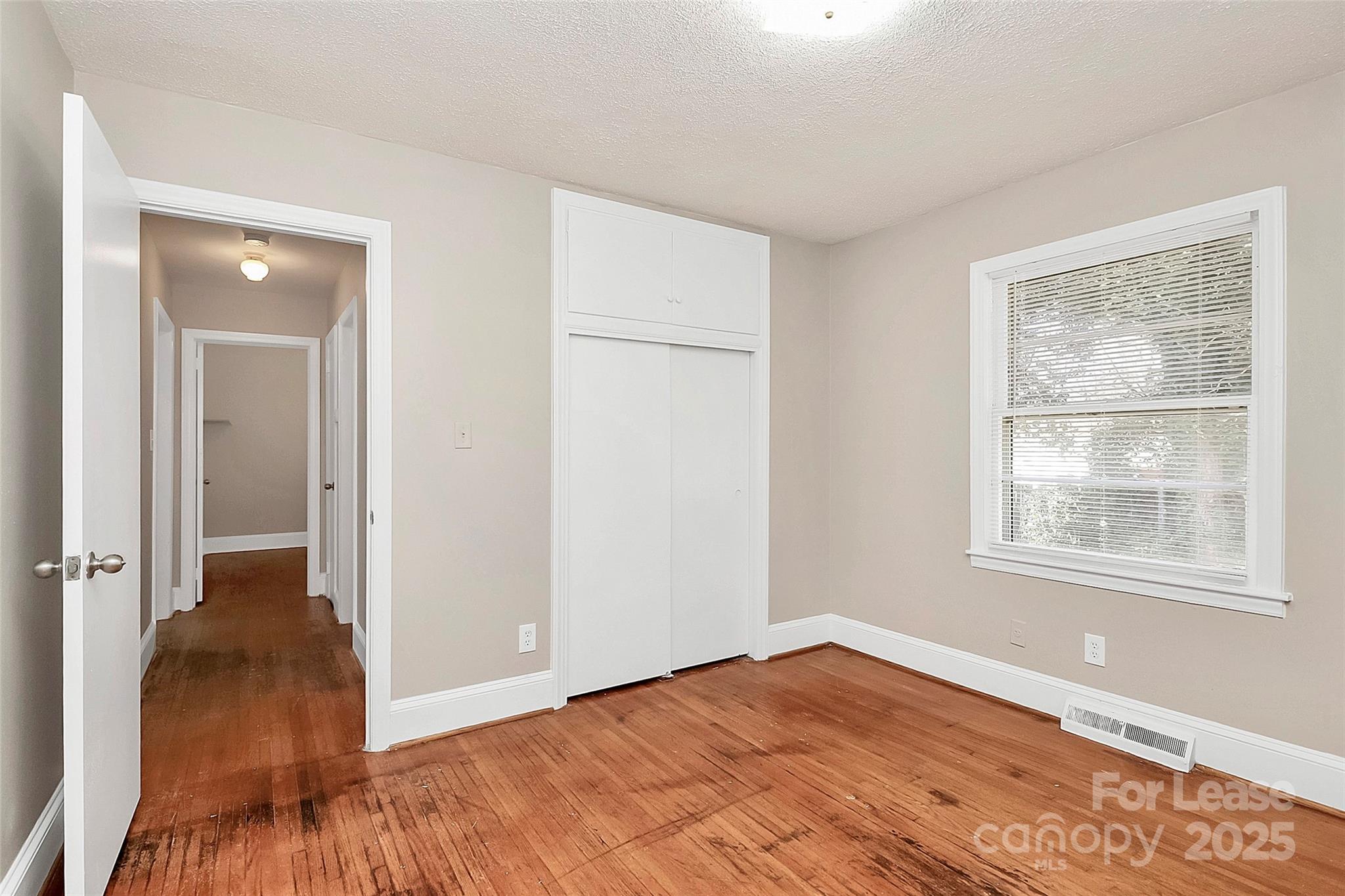 4919 Raymond Place Charlotte, NC 28205 - Photo 12 of 31 an empty room with wooden floor and a window