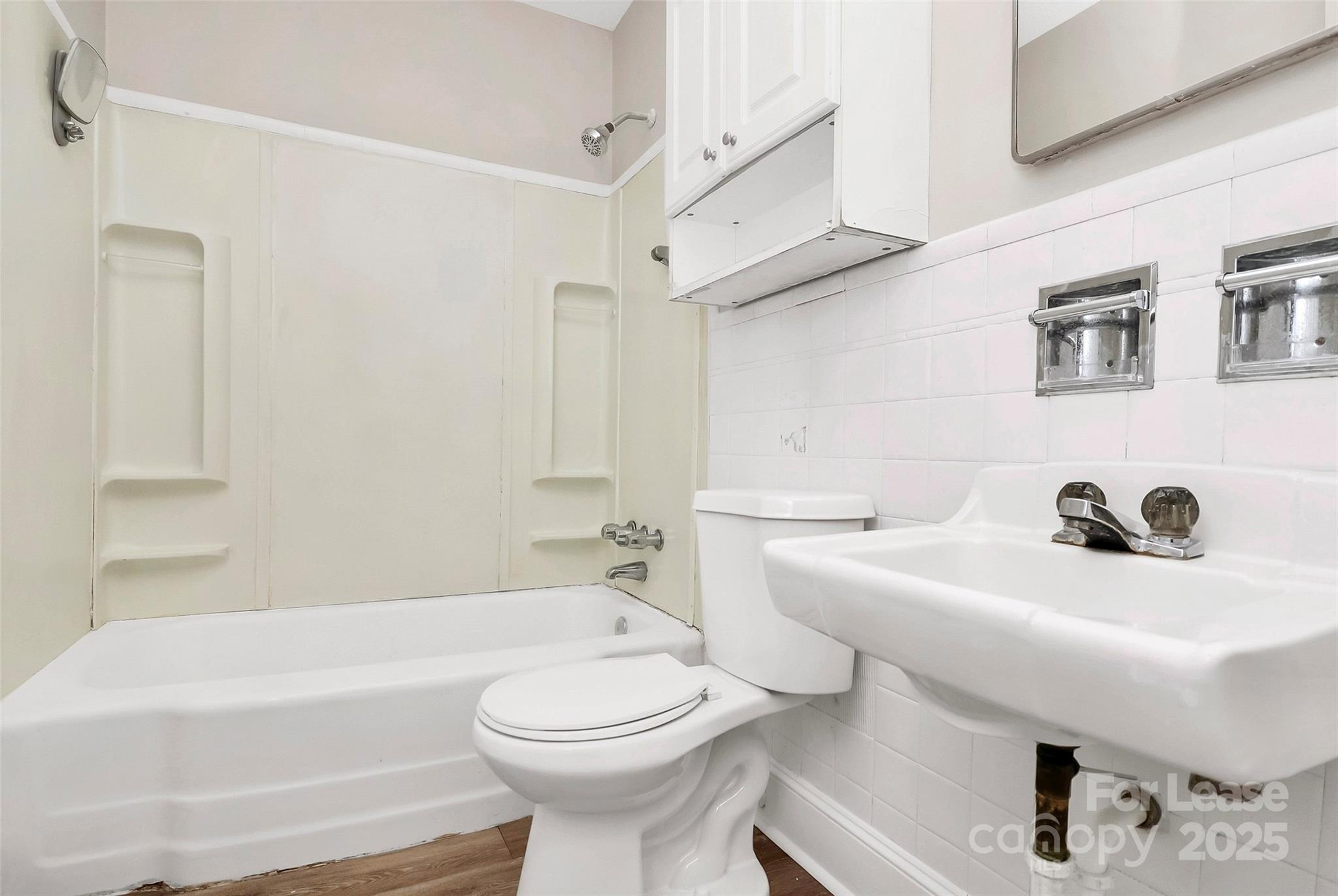 4919 Raymond Place Charlotte, NC 28205 - Photo 13 of 31 a bathroom with a sink a toilet and shower