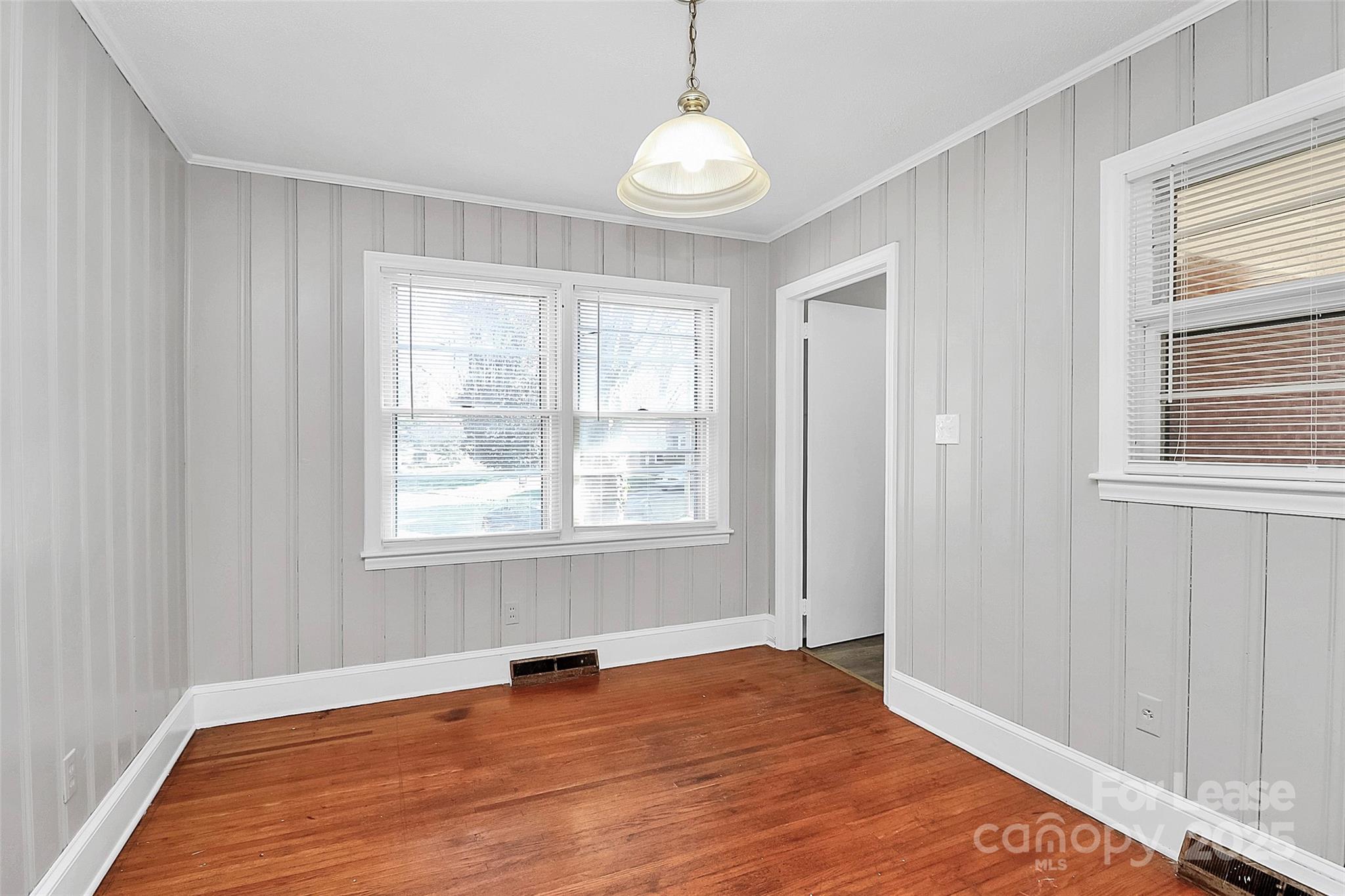 4919 Raymond Place Charlotte, NC 28205 - Photo 21 of 31 a view of an empty room with wooden floor and a window