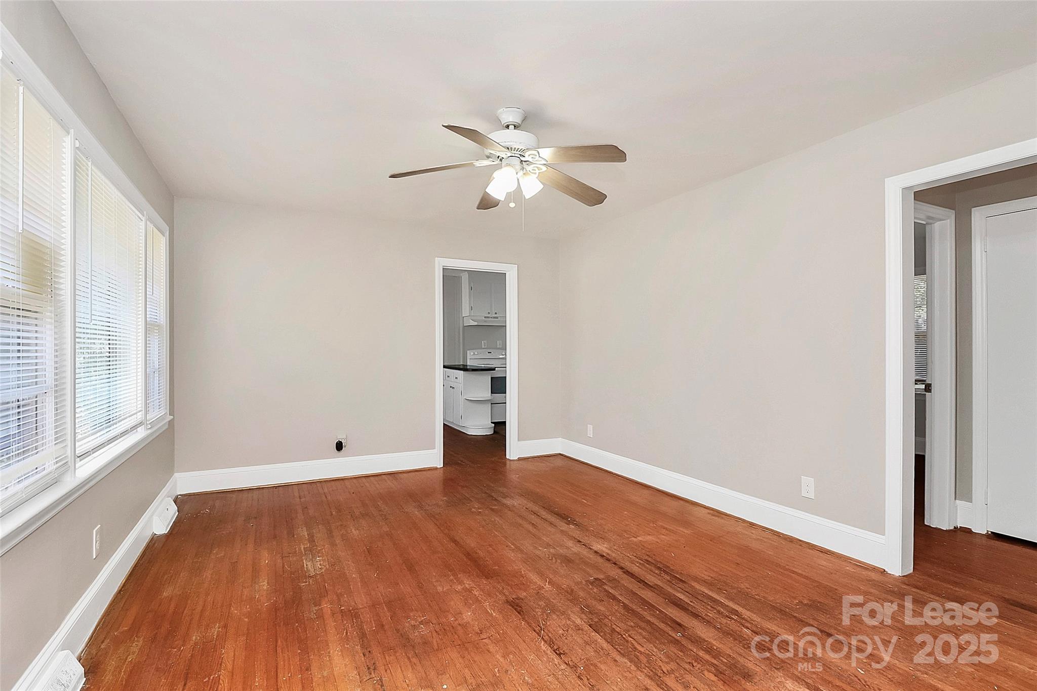 4919 Raymond Place Charlotte, NC 28205 - Photo 7 of 31 wooden floor in an empty room with a window