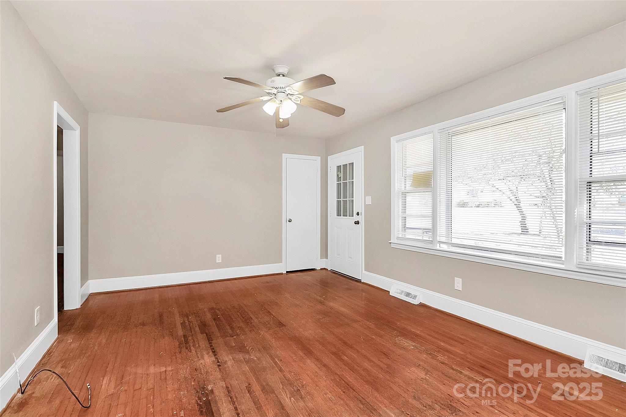 4919 Raymond Place Charlotte, NC 28205 - Photo 8 of 31 a view of an empty room with wooden floor and a window