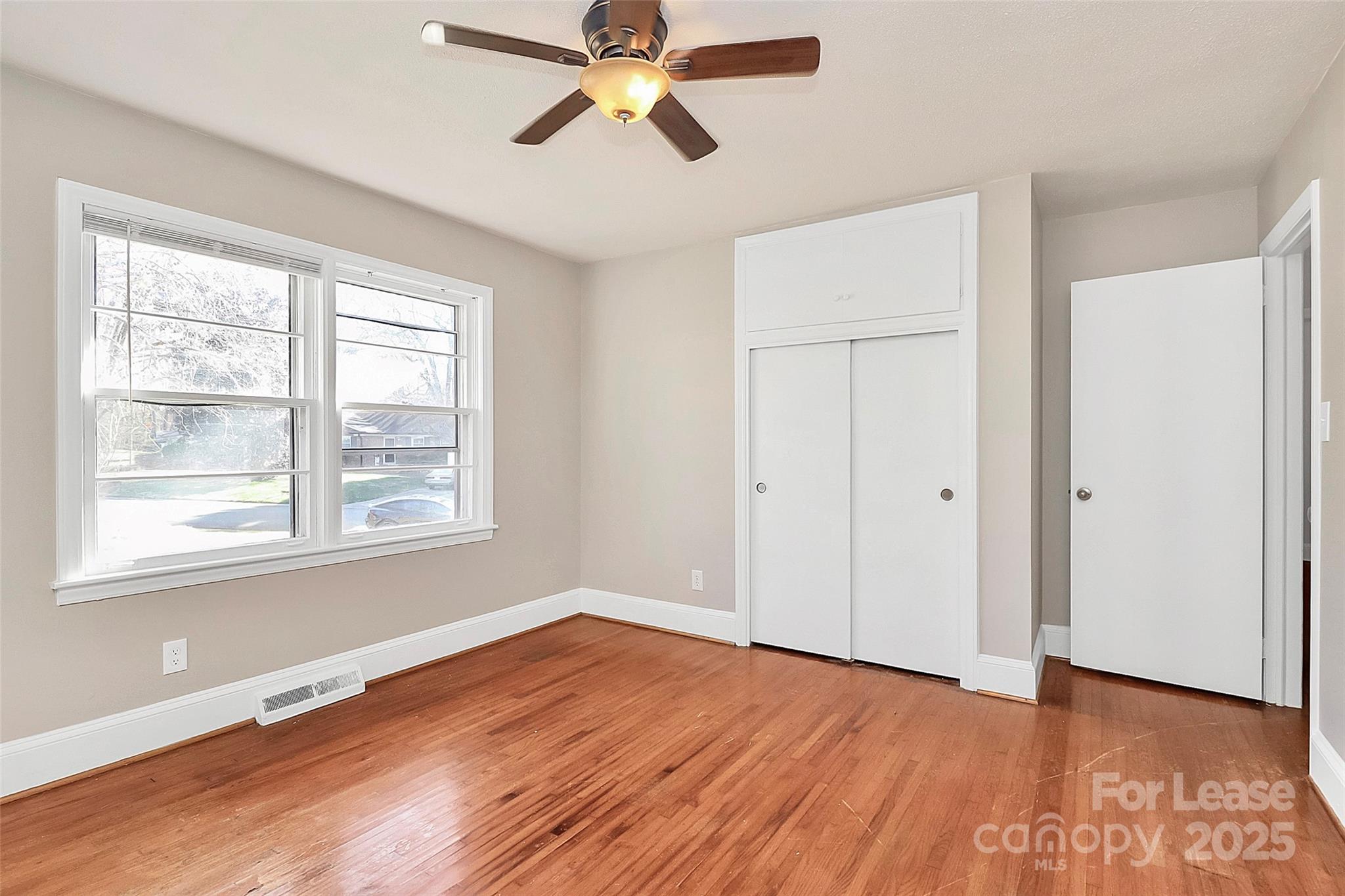 4919 Raymond Place Charlotte, NC 28205 - Photo 10 of 31 a view of empty room with wooden floor and fan