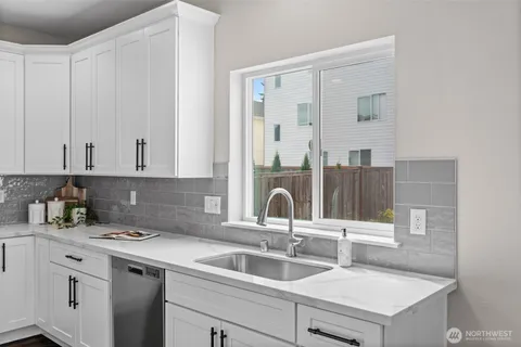 a kitchen with a sink and cabinets