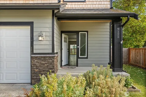 a front view of a house with a garden