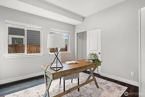 a workspace room with furniture and windows