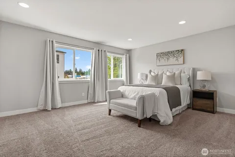 a spacious bedroom with a bed and a cabinets