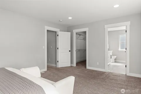 a bedroom with a bed and a bathroom