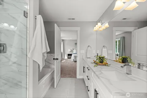 a spacious bathroom with a sink a faucet a mirror and a shower
