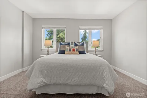 a large bed sitting in a bedroom next to a window