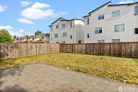 a view of a backyard with wooden fence