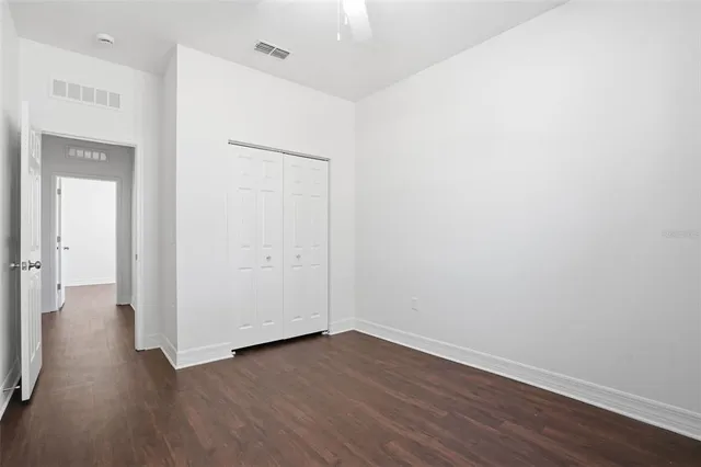 an empty room with wooden floor