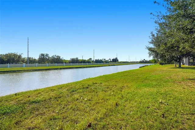 a view of a lake with houses in the background