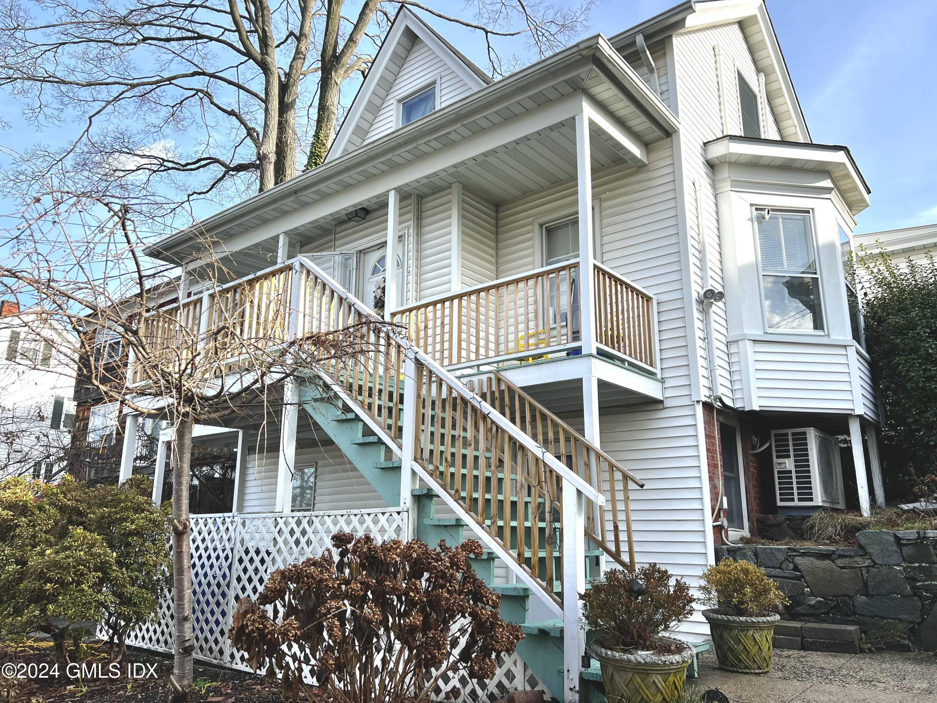 119 North Water Street, Unit 1 Greenwich, CT 06830 - Photo 2 of 11 a front view of a house with a yard