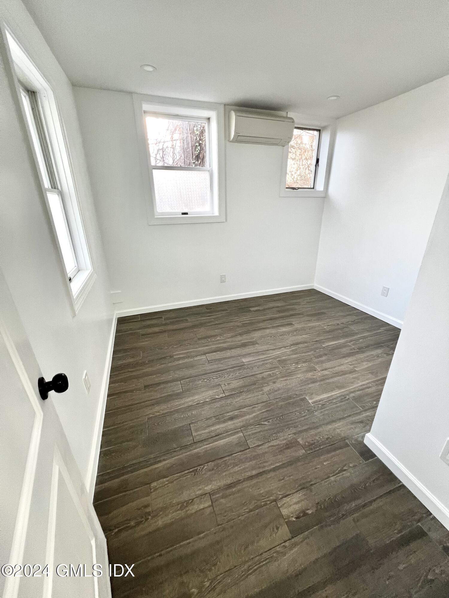 119 North Water Street, Unit 1 Greenwich, CT 06830 - Photo 8 of 11 a view of empty room with wooden floor and fan