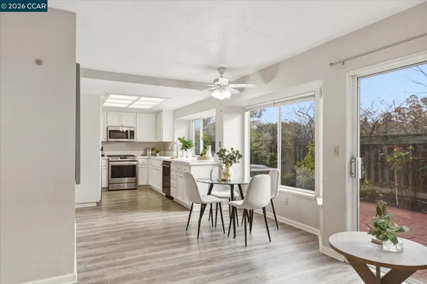 a view of a dining room with furniture window and wooden floor