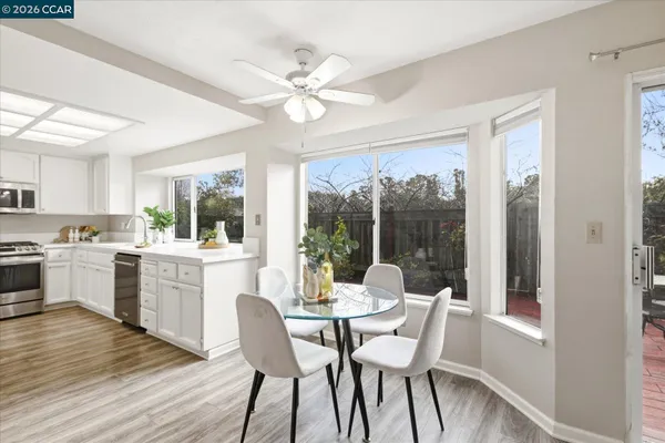a kitchen with a table chairs sink and cabinets