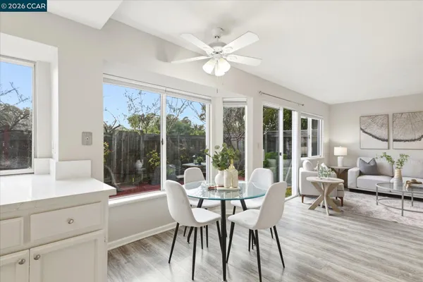 a dining room with furniture a chandelier and wooden floor