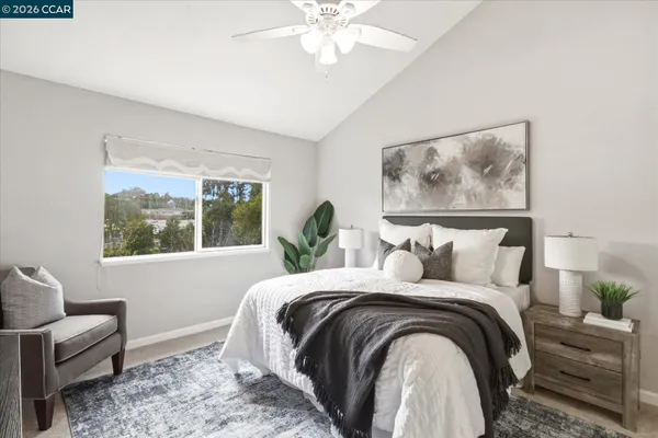 a bedroom with a bed and a painting on the wall