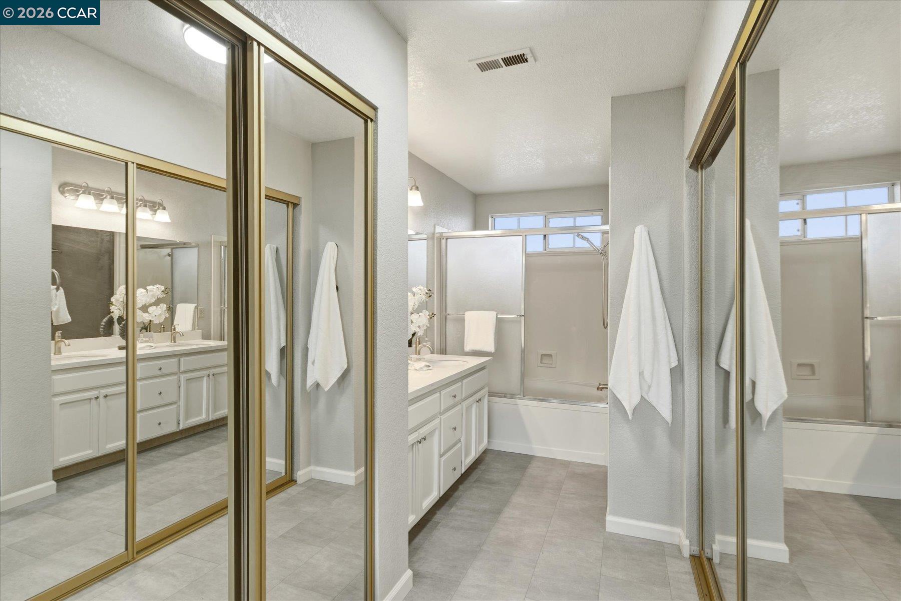 115 Cardoza Hercules, CA 94547 - Photo 23 of 35 a bathroom with a glass door shower a sink and a mirror