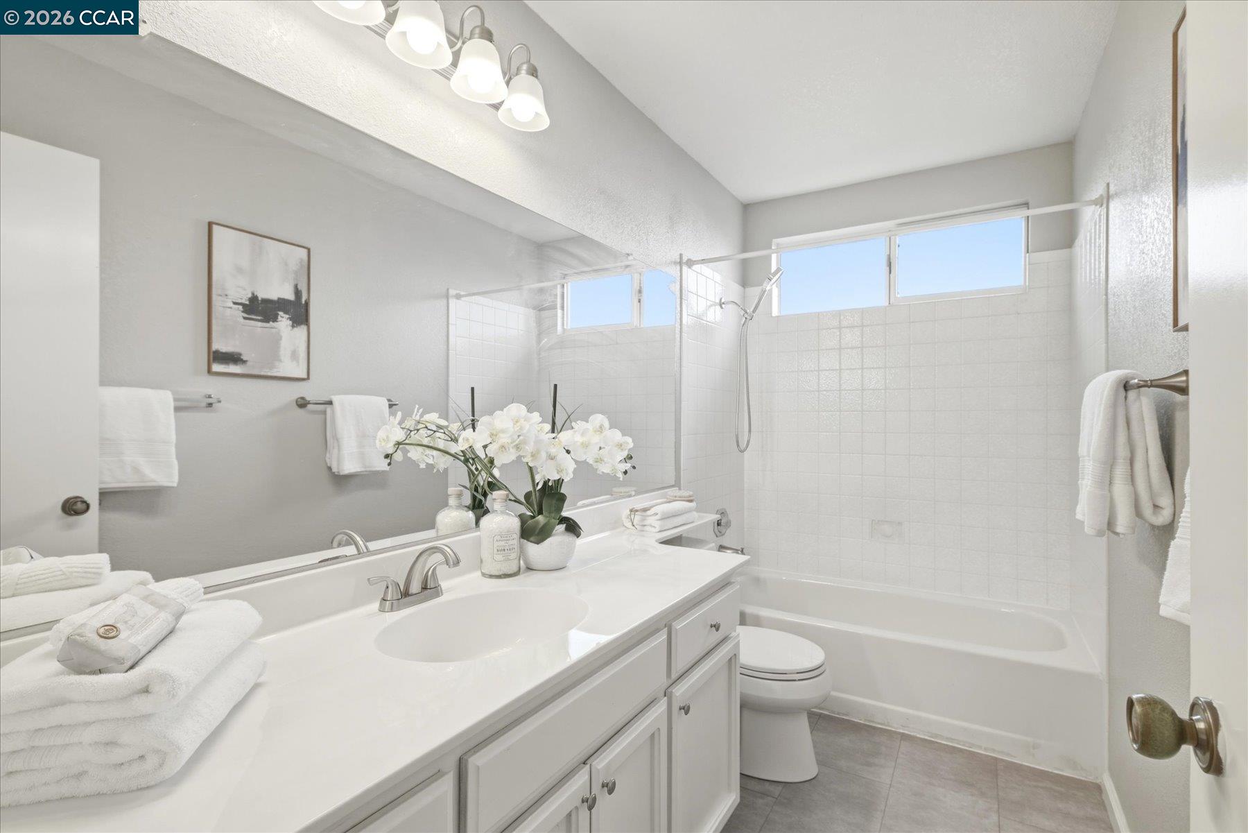 115 Cardoza Hercules, CA 94547 - Photo 27 of 35 a bathroom with a double vanity sink toilet mirror and shower