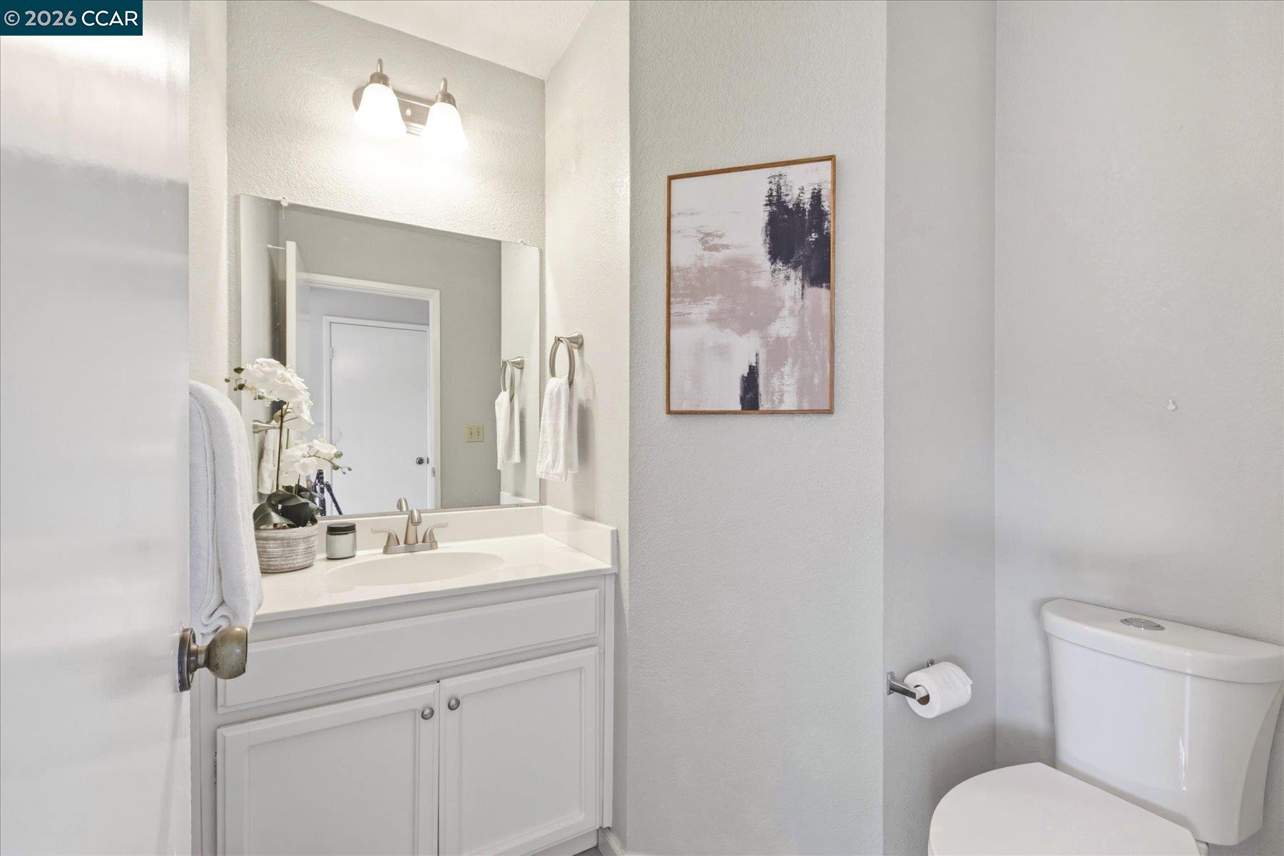 115 Cardoza Hercules, CA 94547 - Photo 28 of 35 a bathroom with a toilet sink and mirror