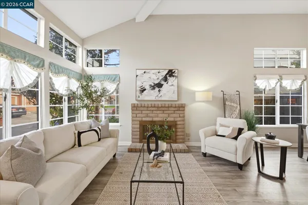a living room with furniture and a fireplace