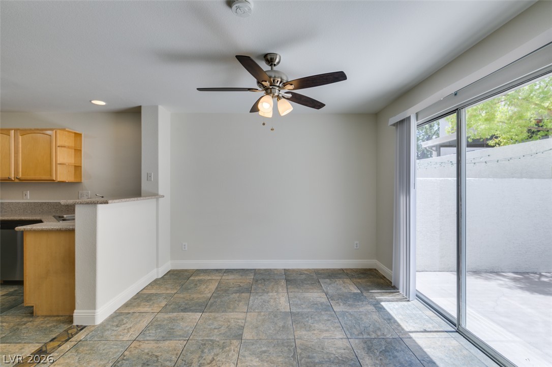 200 Luninborg Street Henderson, NV 89074 - Photo 40 of 40 Floor-to-ceiling sliding glass doors bathe this open-concept living area in abundant natural light.
