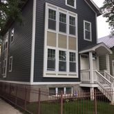 a front view of a house with glass windows