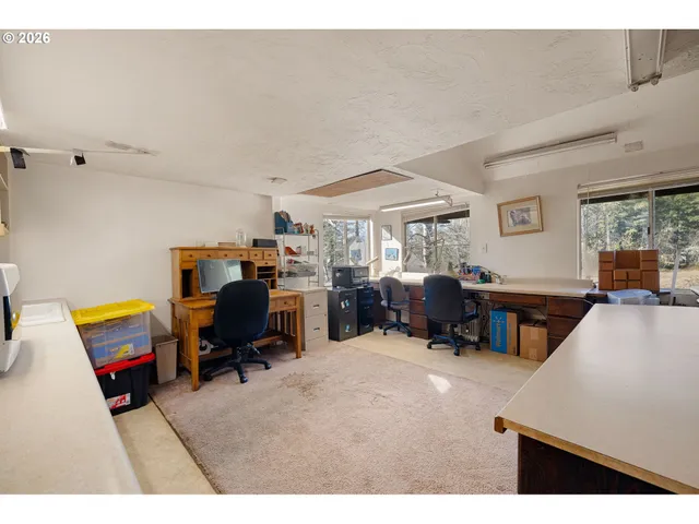 a living room with furniture and a gym machine