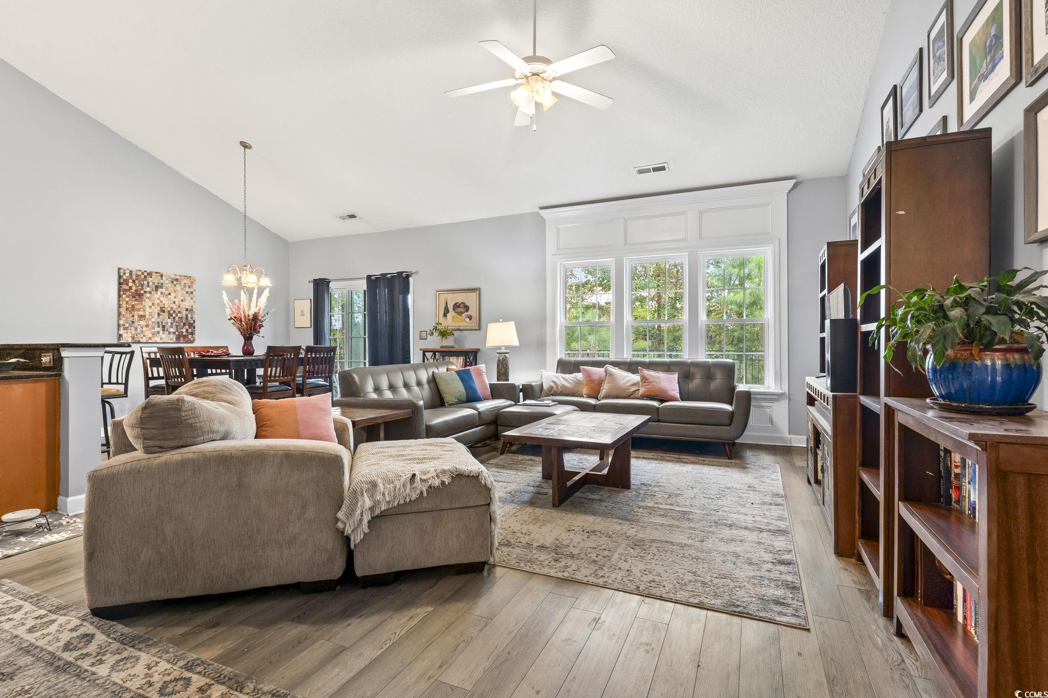 785 Rambler Court Myrtle Beach, SC 29588 - Photo 21 of 25 Living room with high vaulted ceiling, ceiling fan with notable chandelier, and light wood-type flooring