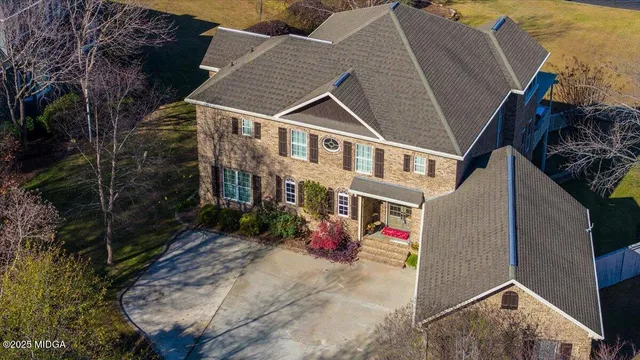 a large kitchen with granite countertop a large counter top appliances and cabinets