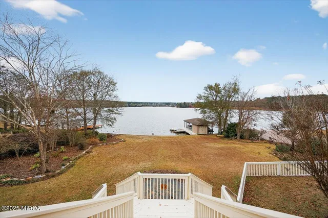 a view of a house with a yard and sitting area
