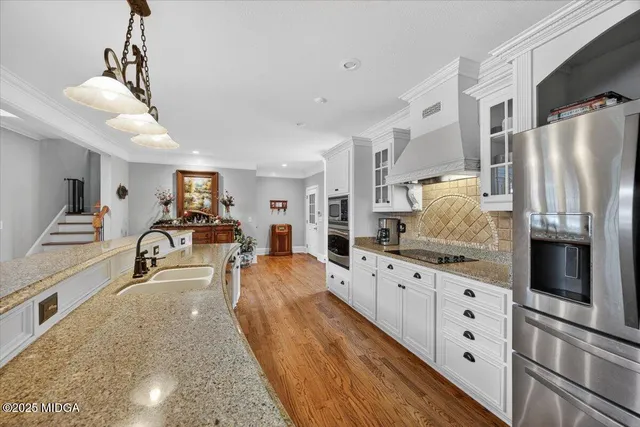 a living room with furniture kitchen and a chandelier