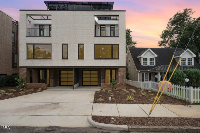 a view of a brick house with many windows