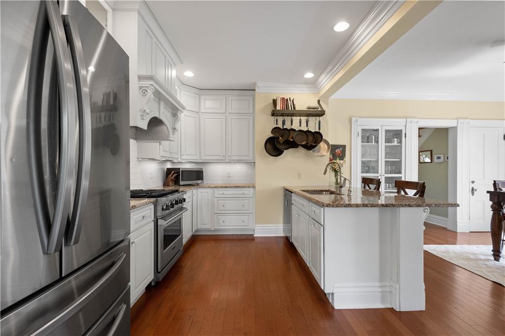 607 Broad Street Sewickley, PA 15143 - Photo 11 of 45 a kitchen with stainless steel appliances granite countertop a refrigerator and a stove top oven