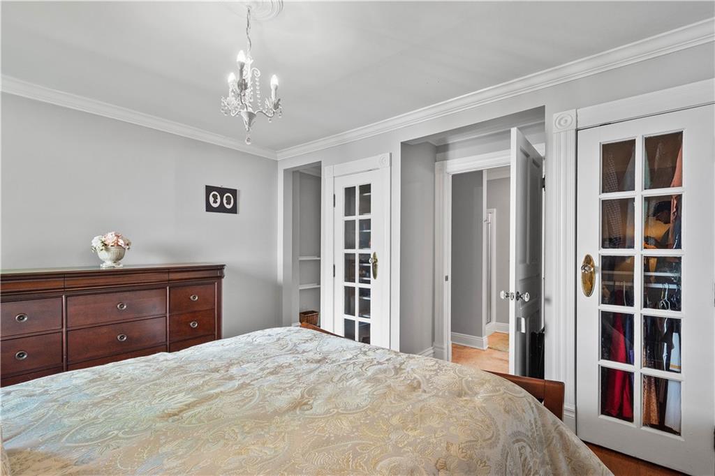607 Broad Street Sewickley, PA 15143 - Photo 26 of 45 a bedroom with a large bed and a chandelier