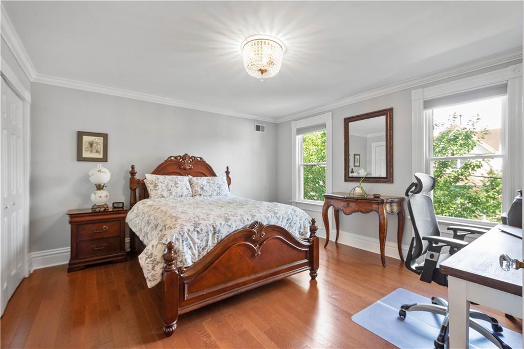 607 Broad Street Sewickley, PA 15143 - Photo 29 of 45 a bedroom with a bed and wooden floor