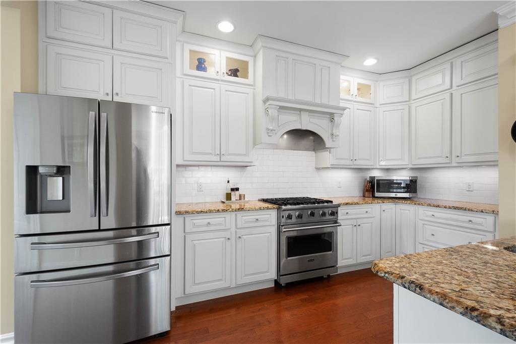 607 Broad Street Sewickley, PA 15143 - Photo 3 of 45 a kitchen with white cabinets and stainless steel appliances