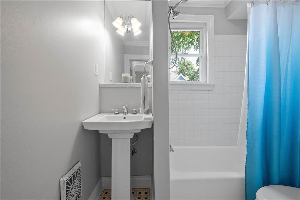 607 Broad Street Sewickley, PA 15143 - Photo 31 of 45 a bathroom with a sink a mirror and a bathtub