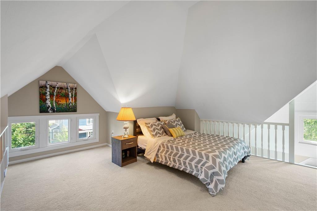 607 Broad Street Sewickley, PA 15143 - Photo 32 of 45 a bedroom with a bed and a lamp on table