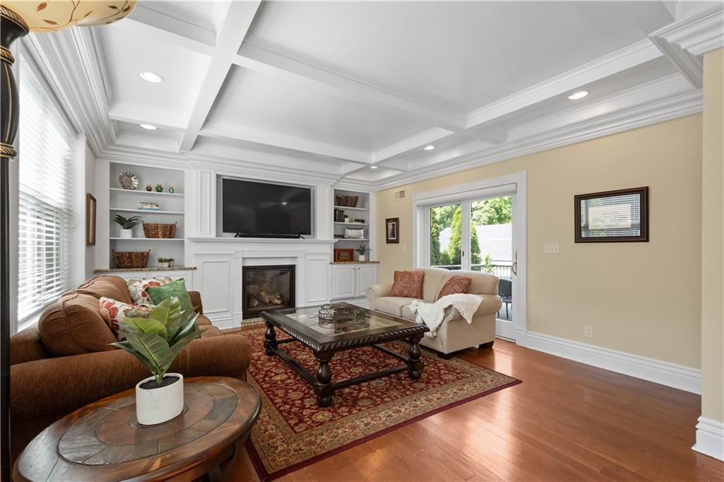 607 Broad Street Sewickley, PA 15143 - Photo 4 of 45 a living room with furniture a fireplace and a flat screen tv