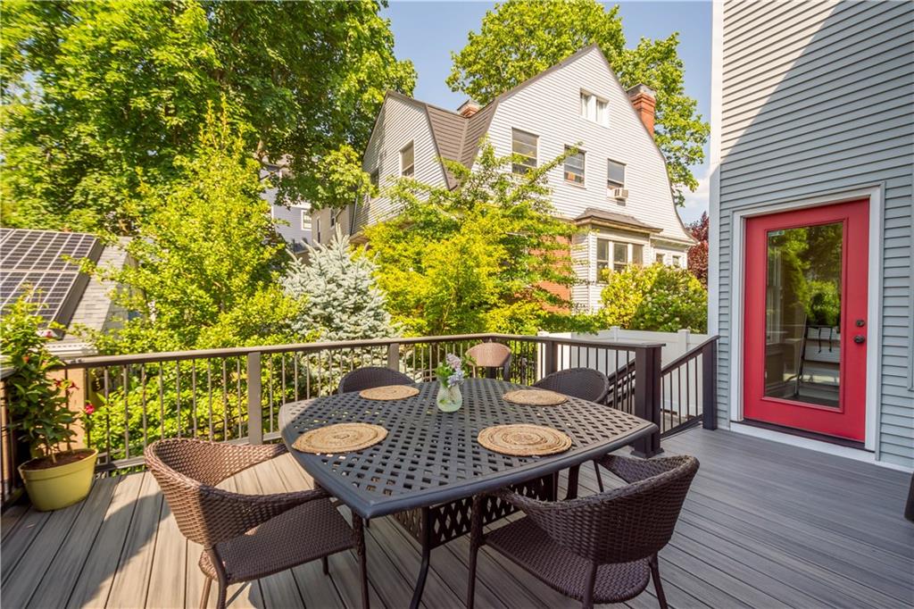 607 Broad Street Sewickley, PA 15143 - Photo 41 of 45 a balcony with wooden floor table and chairs