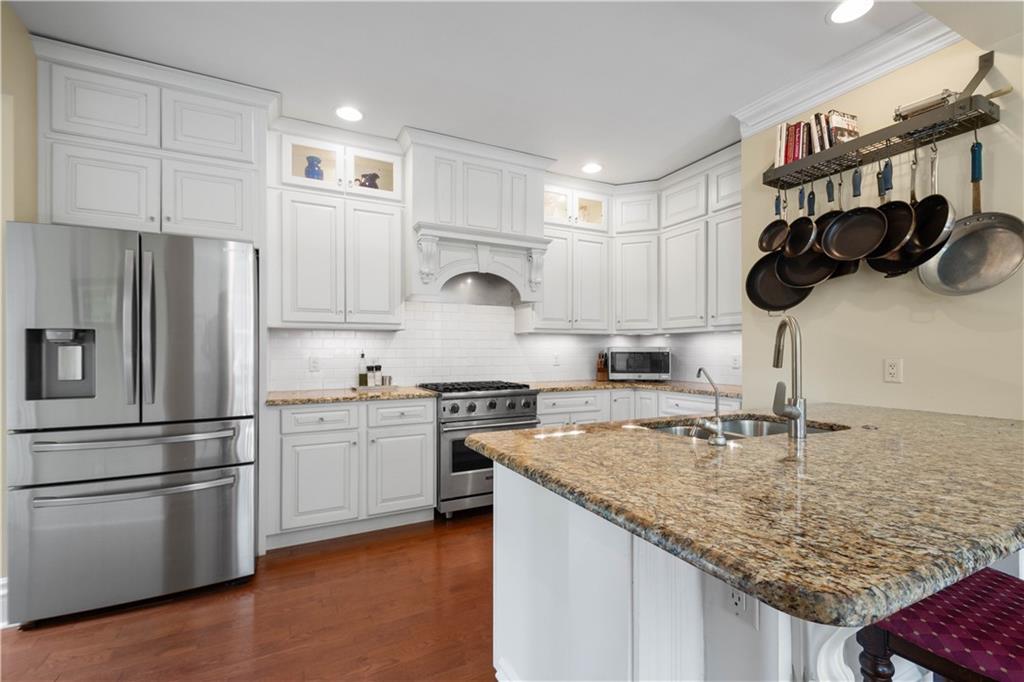 607 Broad Street Sewickley, PA 15143 - Photo 10 of 45 a kitchen with white cabinets and stainless steel appliances