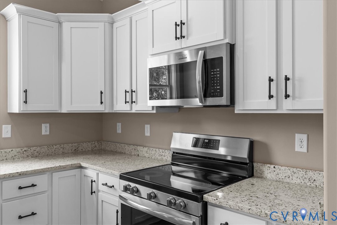 2229 North Terry's Bridge Road Halifax, VA 24558 - Photo 23 of 42 a kitchen with granite countertop white cabinets and stainless steel appliances