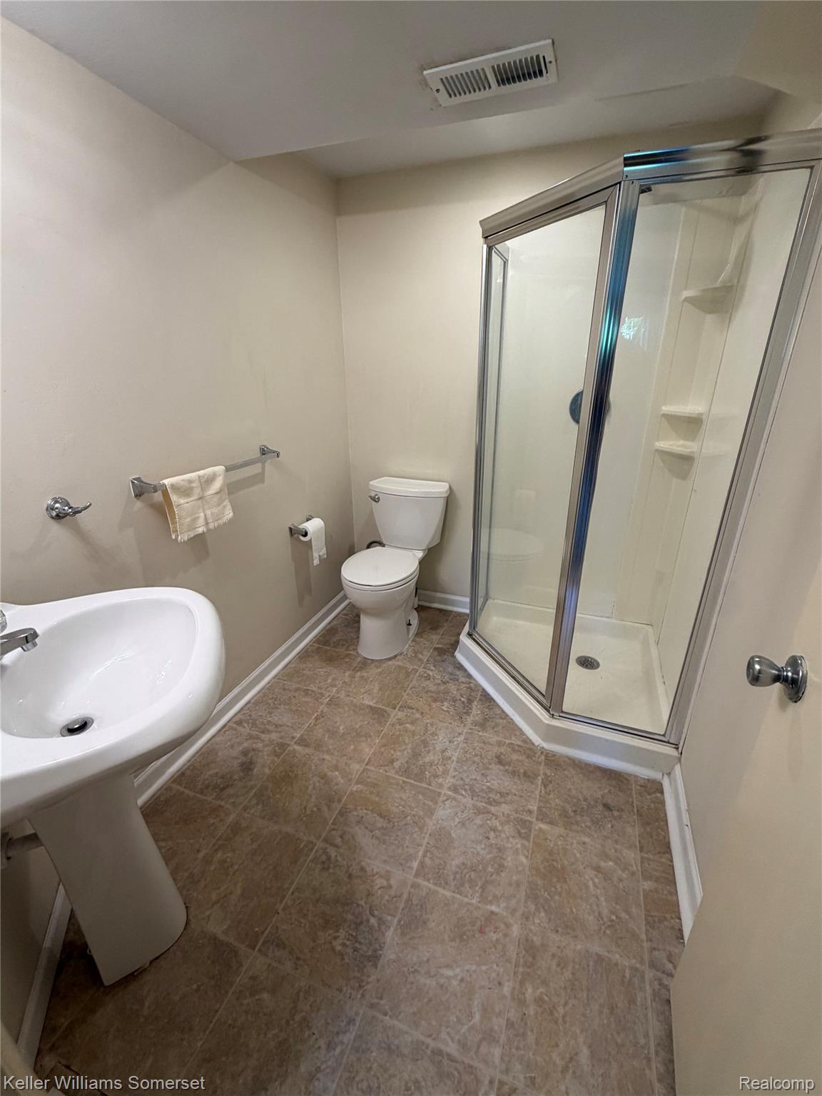 3277 Eastern Avenue Rochester, MI 48307 - Photo 11 of 13 Bathroom featuring a corner shower enclosure with glass panels, pedestal sink, and textured floor tiles