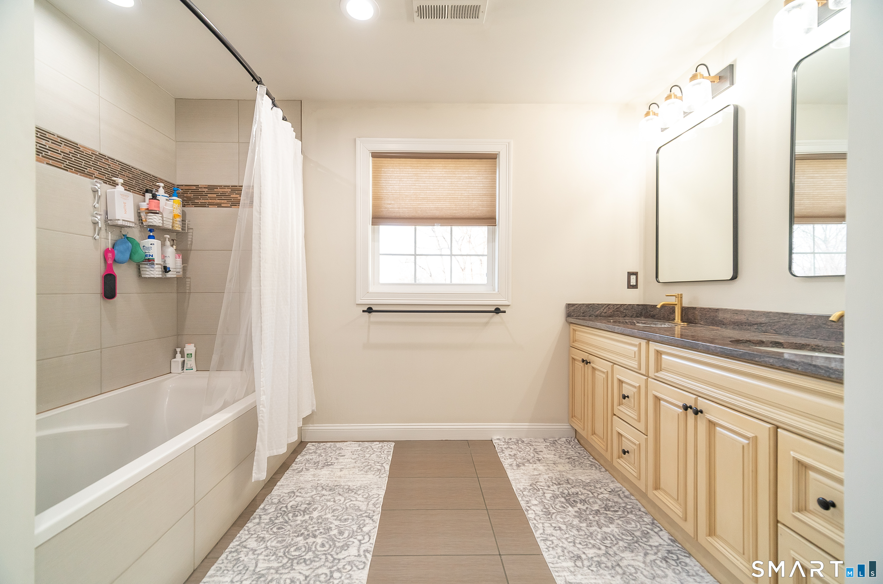 69 Cronin Street Bristol, CT 06010 - Photo 13 of 40 a bathroom with a tub sink and mirror