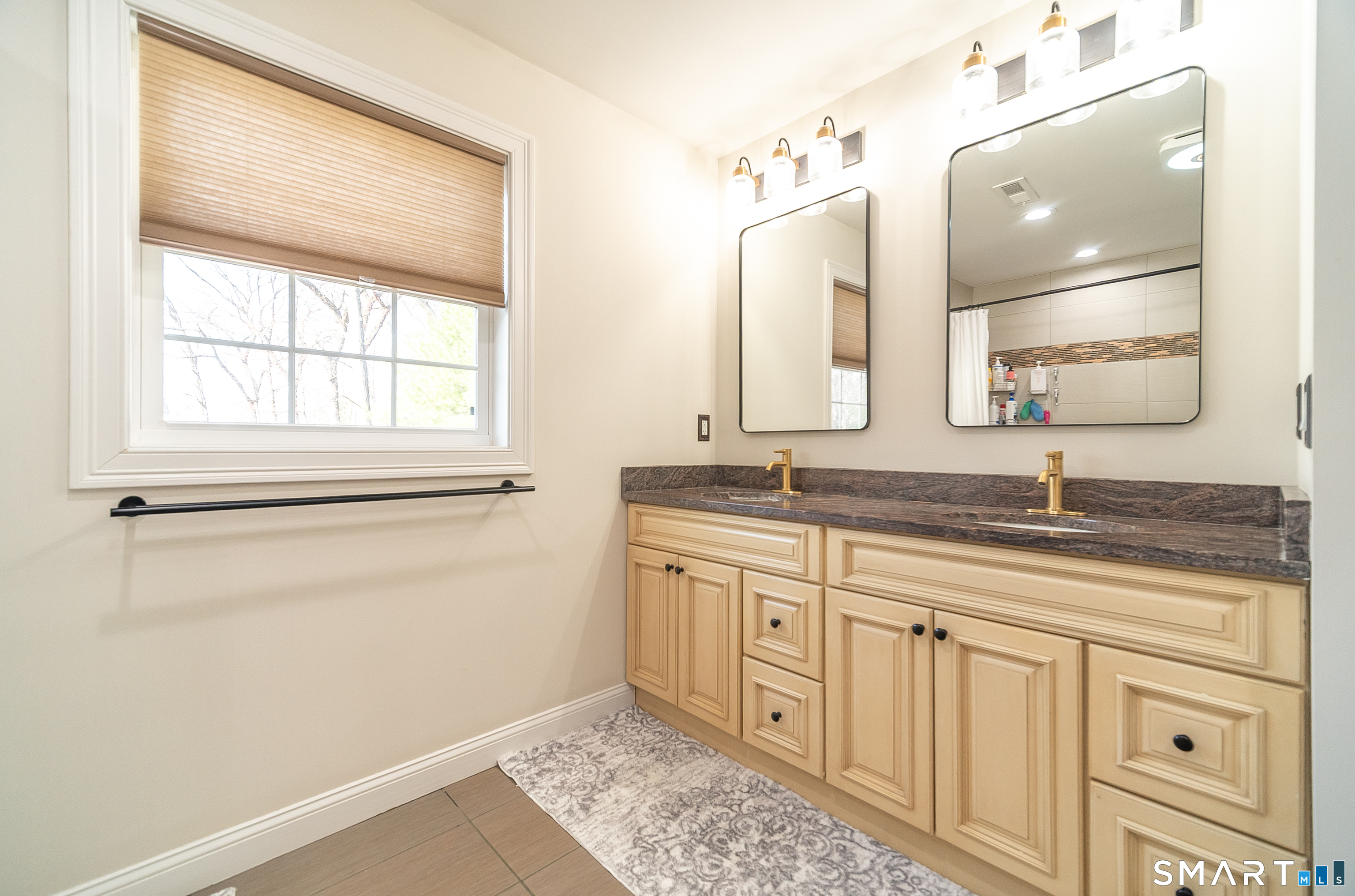 69 Cronin Street Bristol, CT 06010 - Photo 14 of 40 a bathroom with a granite countertop sink a mirror and a
