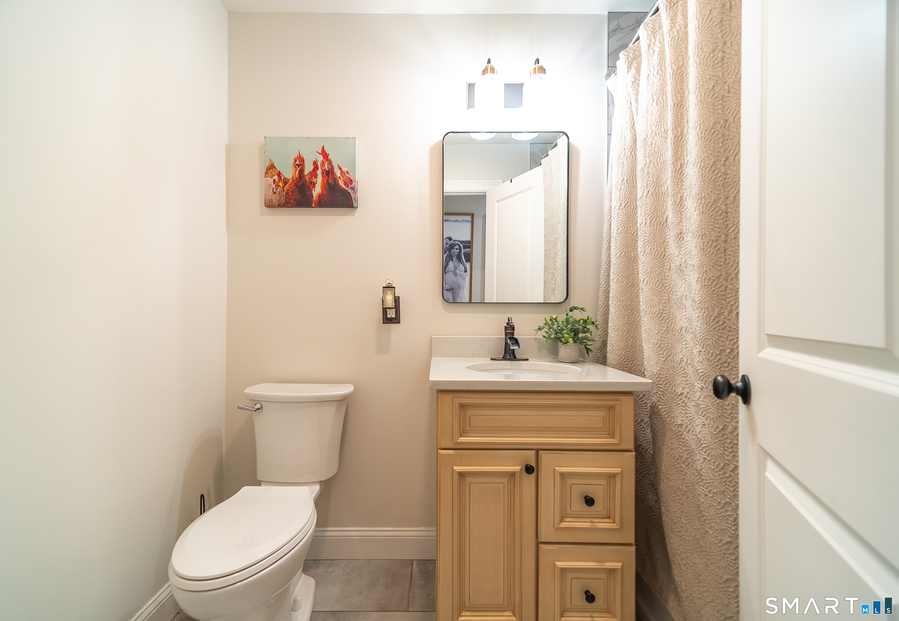 69 Cronin Street Bristol, CT 06010 - Photo 18 of 40 a bathroom with a toilet a sink and a mirror